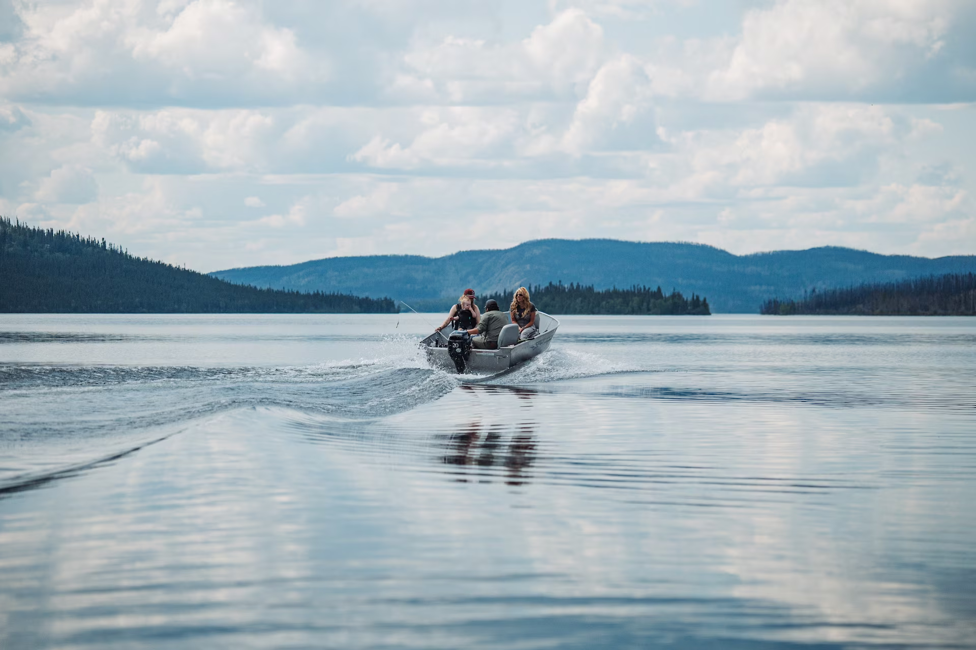 A motorboat speeding through Tazin Lake.